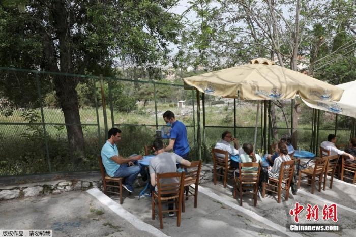 資料圖：希臘雅典，人們在一家露天咖啡享用飲品。