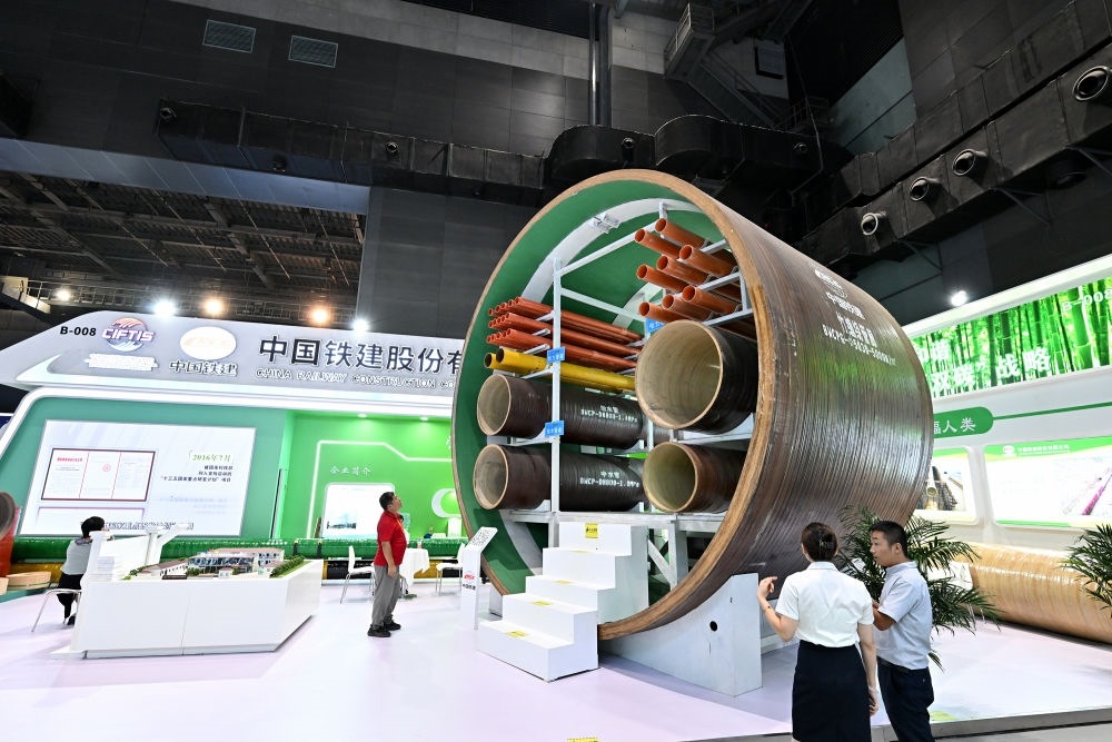 9月2日，在國家體育館舉行的服貿(mào)會(huì)環(huán)境服務(wù)專題展上，客商在中國鐵建展位竹纏繞管廊旁了解信息。新華社記者 李鑫 攝