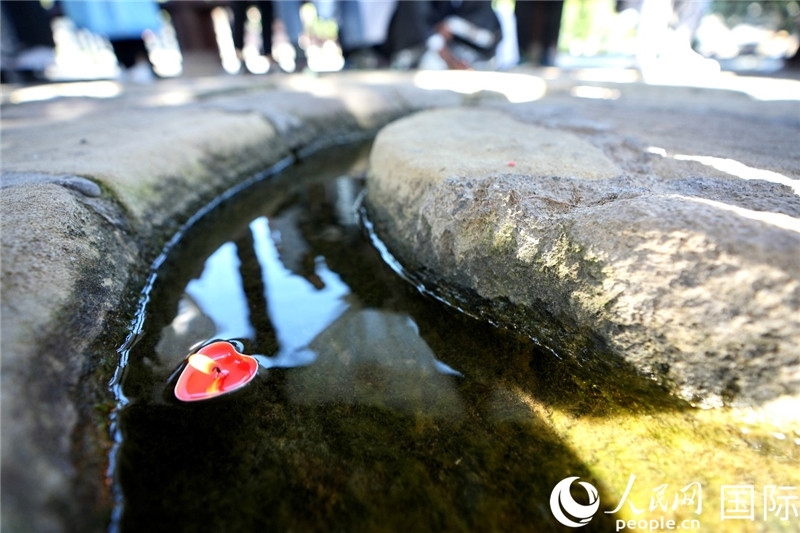 圖為水渠里流過的“桃心”蠟燭。人民網(wǎng) 盧鵬宇攝