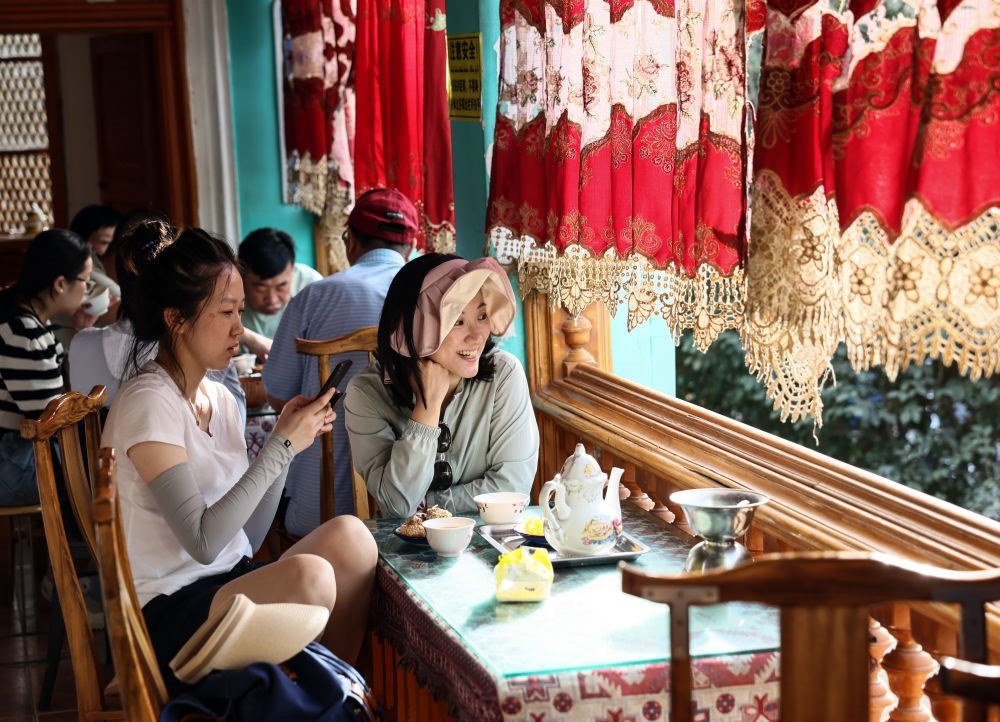 游客在新疆喀什古城景區(qū)百年老茶館內(nèi)品茶小憩（2023年9月7日攝）。新華社記者 蘭紅光 攝