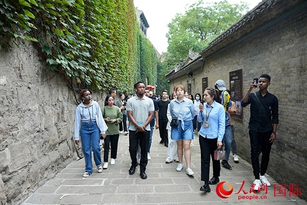 選手們認(rèn)真聆聽導(dǎo)游講解。人民網(wǎng) 盧鵬宇攝