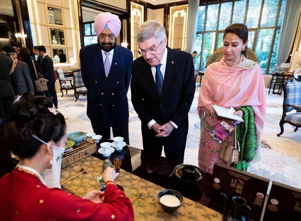 △歡迎宴會(huì)前，亞奧理事會(huì)代理主席辛格和夫人維尼塔、國際奧委會(huì)主席巴赫欣賞非遺展示。