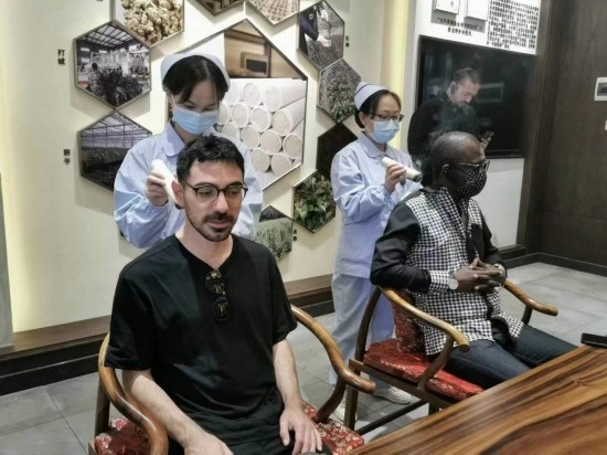 2023“一帶一路”媒體合作論壇聯(lián)合采訪(fǎng)團(tuán)團(tuán)員在九牛草展示館體驗(yàn)艾灸。（本報(bào)記者 黃超攝）