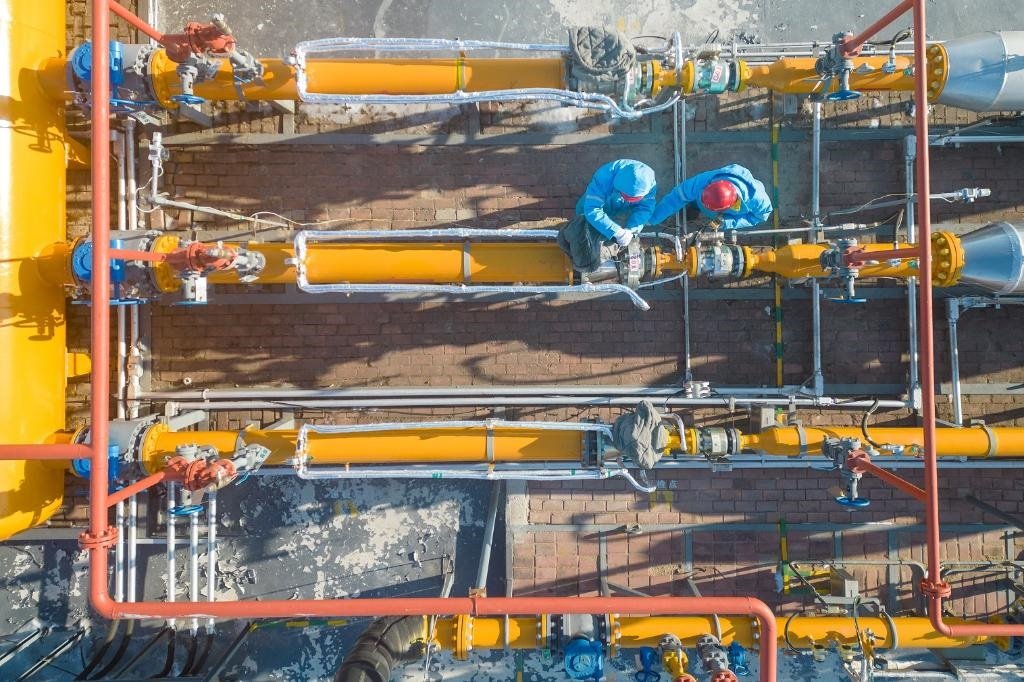 12月17日，黑龍江省哈爾濱市中慶燃氣有限責(zé)任公司成高子門站的工作人員在進行設(shè)備巡檢，保障燃氣供應(yīng)（無人機照片）。 新華社記者 張濤 攝