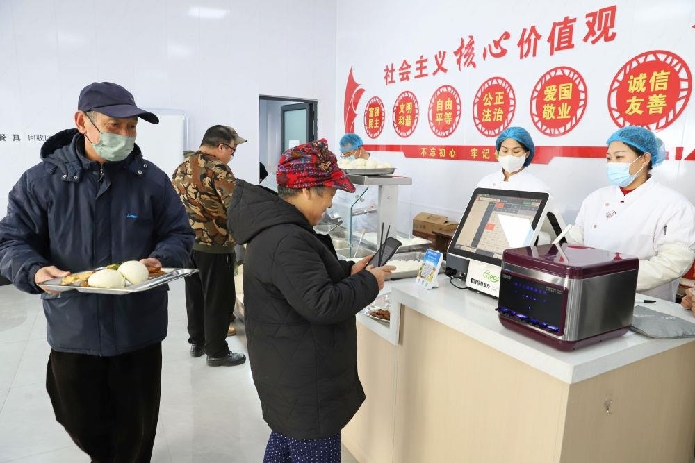 △2024年2月1日，市民在河北涿州市雙塔街道永濟(jì)秀園小區(qū)便民食堂內(nèi)購(gòu)買午餐。