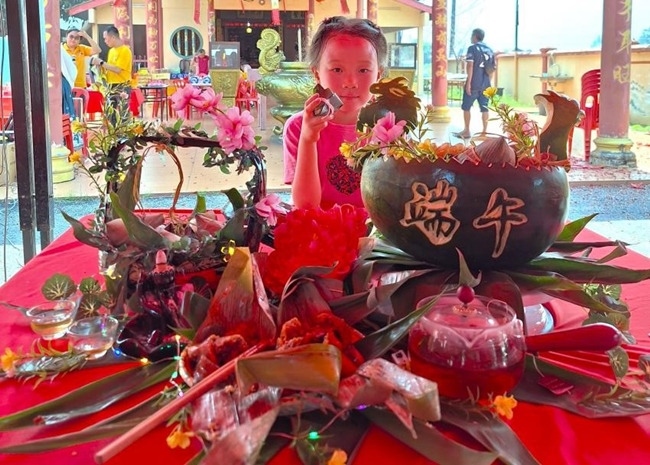 小朋友展示學(xué)裹粽子的成品照。組委會(huì)供圖