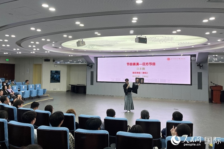 日本大學生介紹能樂知識。人民網(wǎng)記者 陳思攝