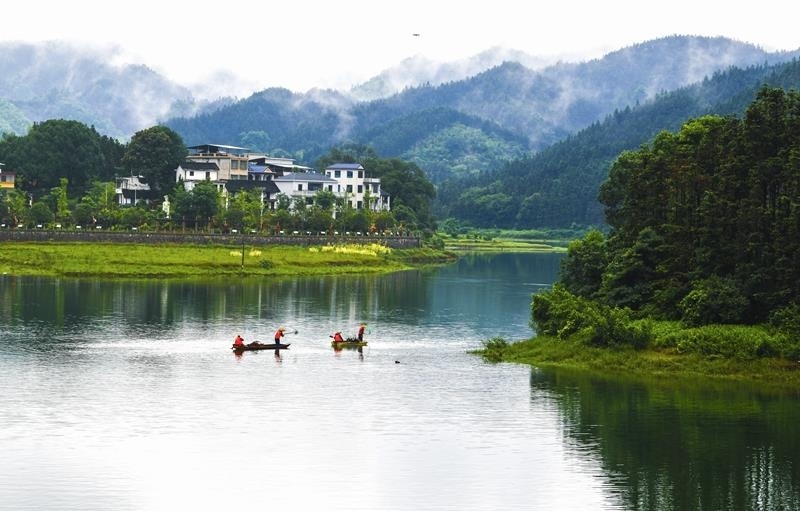 2024年6月5日，志愿者在湖南常寧市洋泉水庫清理水面漂浮物。