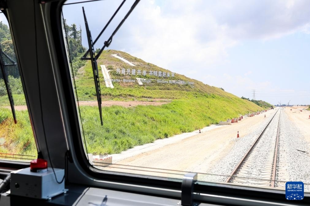 5月6日，在馬來西亞彭亨州馬東鐵項(xiàng)目沿途的山坡上，兩行中文和馬來文大字“共商共建共享，共創(chuàng)美好未來”映入眼簾。新華社記者 程一恒 攝