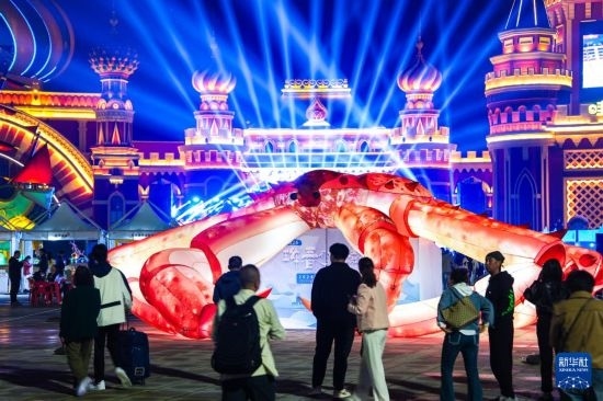 9月19日，游客在吉林省琿春市的2024琿春帝王蟹美食嘉年華現(xiàn)場游玩。新華社記者 許暢 攝