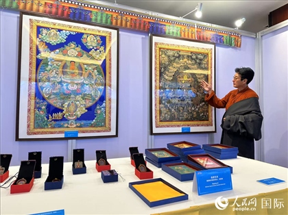 熱貢藝術(shù)國(guó)家級(jí)代表性傳承人夏吾角向嘉賓介紹作品。人民網(wǎng)記者 簡(jiǎn)承淵攝