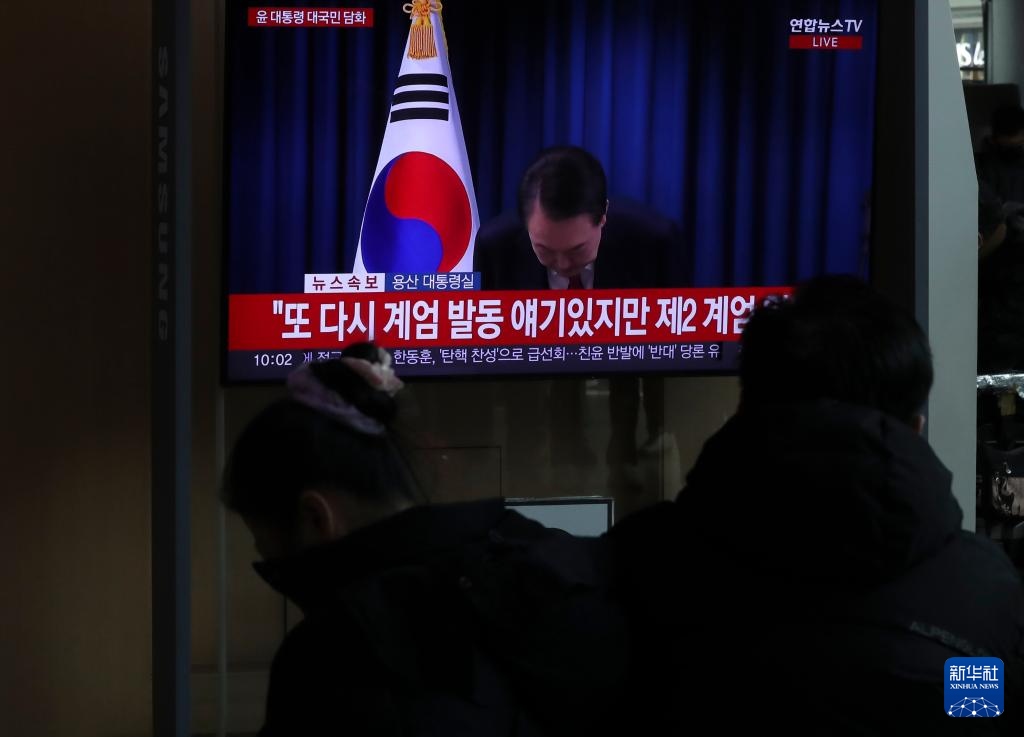 12月7日，在韓國首爾火車站，民眾觀看總統(tǒng)尹錫悅發(fā)表講話的電視畫面。新華社記者 姚琪琳 攝