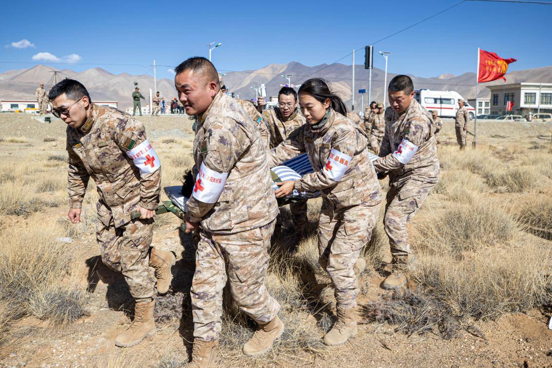 1月9日，日喀則定日縣長所鄉(xiāng)，西藏軍區(qū)總醫(yī)院醫(yī)療隊(duì)隊(duì)員將受傷村民用擔(dān)架從救護(hù)車準(zhǔn)備抬上直升機(jī)，轉(zhuǎn)運(yùn)至拉薩的西藏軍區(qū)總醫(yī)院救治。人民日?qǐng)?bào)記者張武軍攝