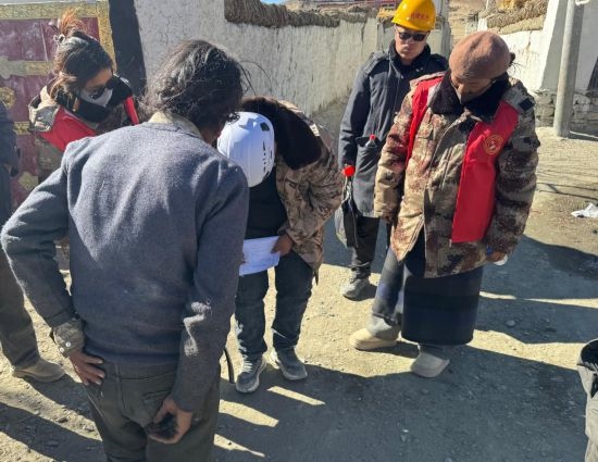 1月13日，次旺（右一）陪同工作組走訪村莊，評估房屋受損程度。新華社發(fā)